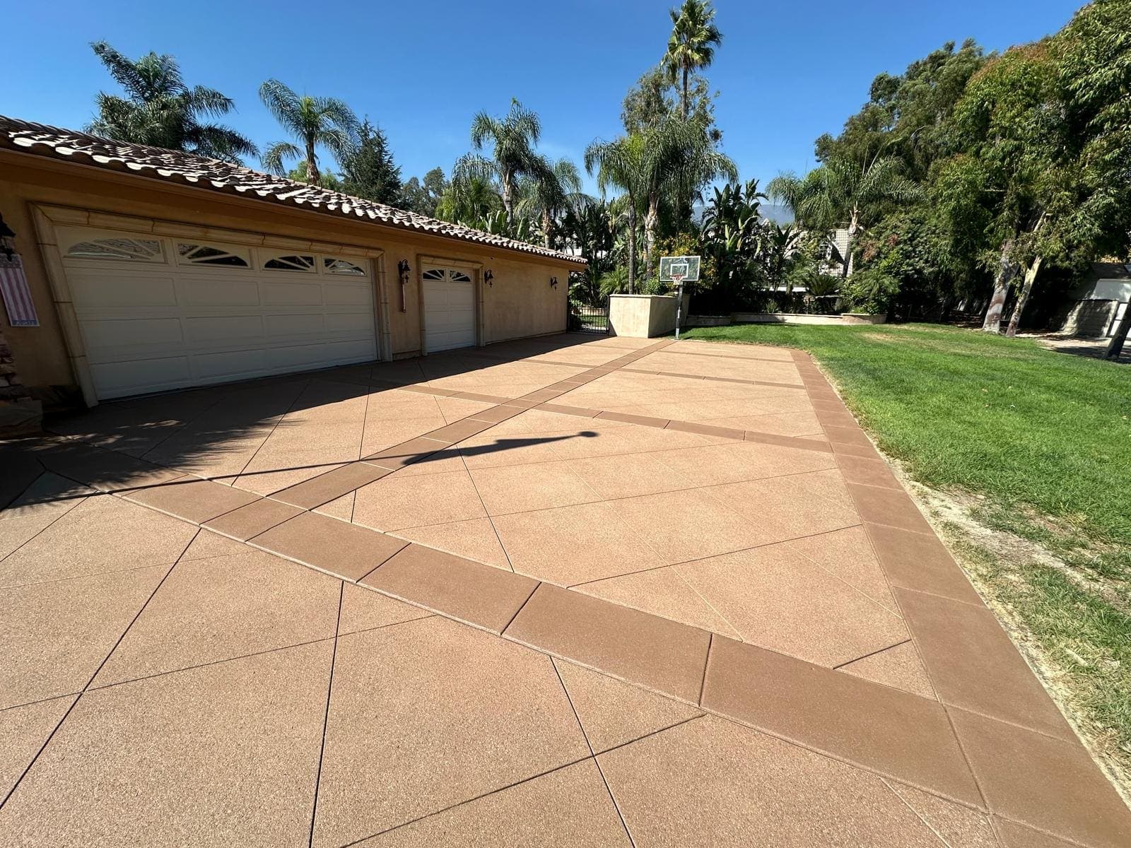 Integral color concrete driveway with a soldier-course border