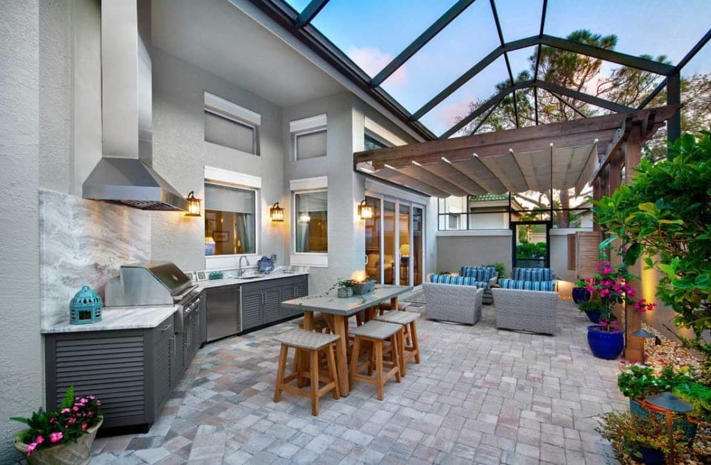 Outdoor kitchen and covered living space with a pergola