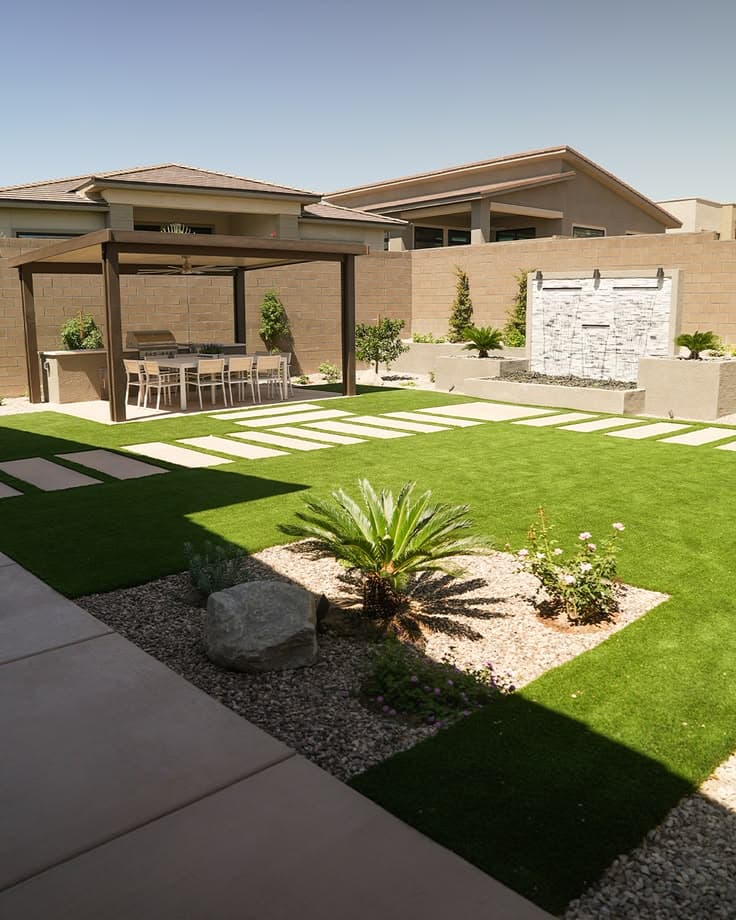 Paver patio, artificial turf, and pergola in a backyard
